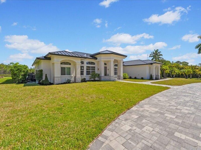 mediterranean / spanish house featuring a front yard