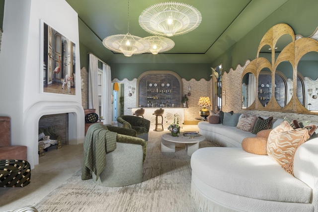 living room with a raised ceiling and a chandelier