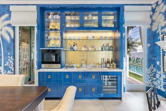 bar featuring blue cabinetry and wine cooler