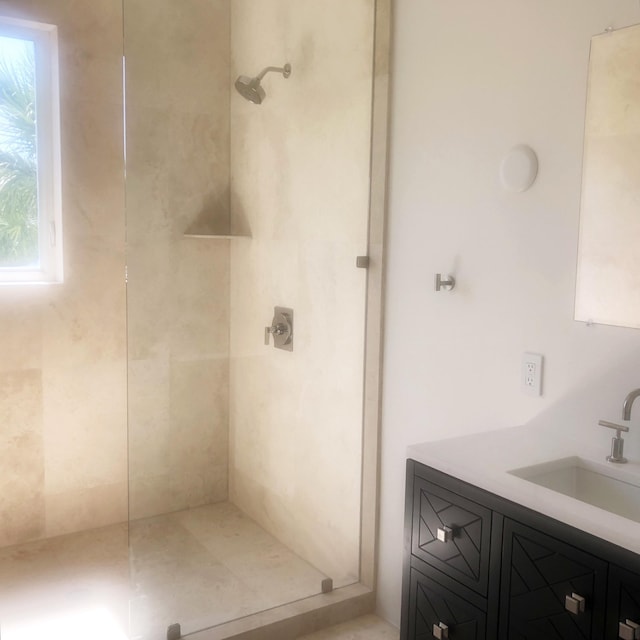 bathroom featuring vanity and tiled shower