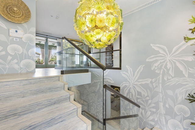 stairway featuring french doors and a chandelier