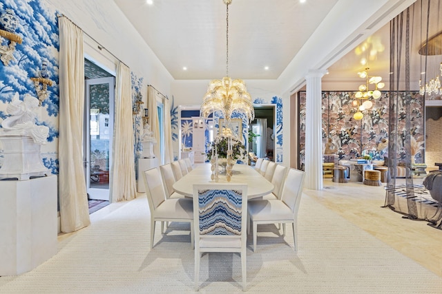 dining space with an inviting chandelier and decorative columns