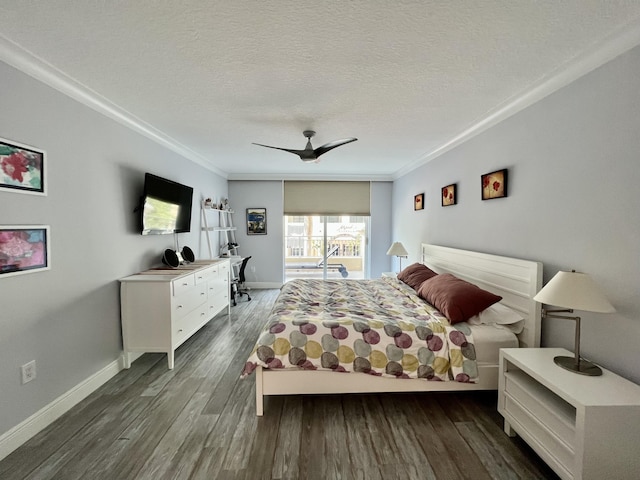 bedroom with ceiling fan, dark wood-type flooring, ornamental molding, and a textured ceiling