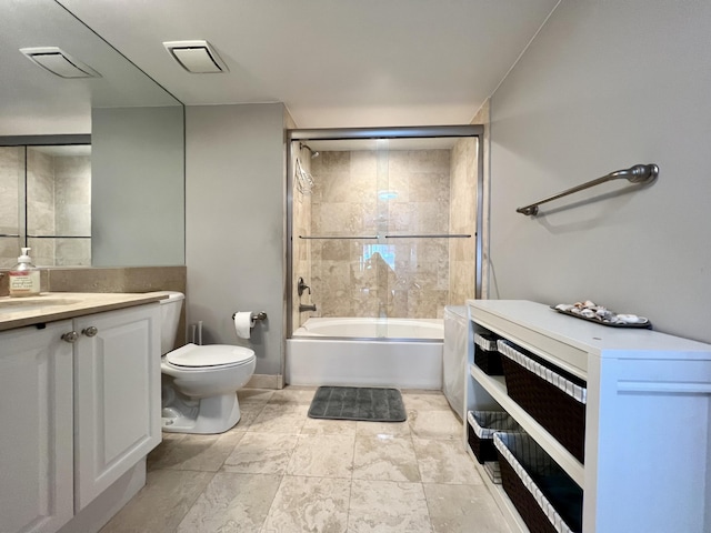 full bathroom featuring vanity, shower / bath combination with glass door, and toilet