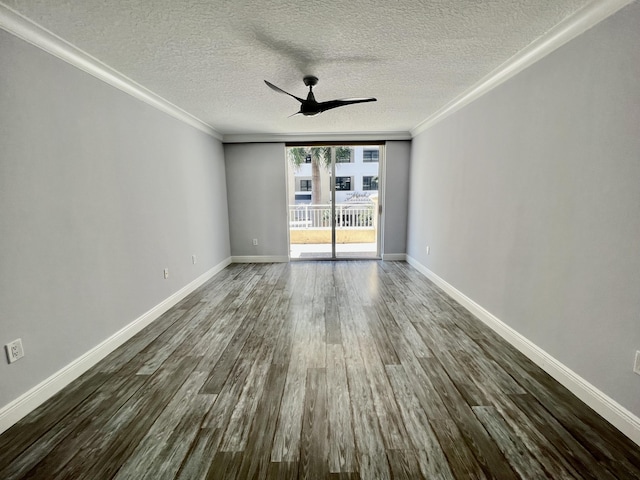 spare room featuring dark hardwood / wood-style floors, expansive windows, ceiling fan, crown molding, and a textured ceiling