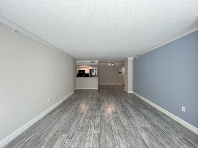 unfurnished living room featuring hardwood / wood-style flooring, ornamental molding, and a textured ceiling