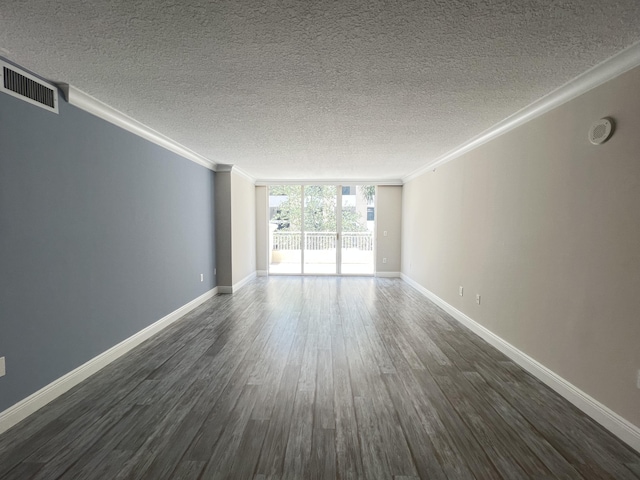 empty room with ornamental molding, dark wood-type flooring, floor to ceiling windows, and a textured ceiling