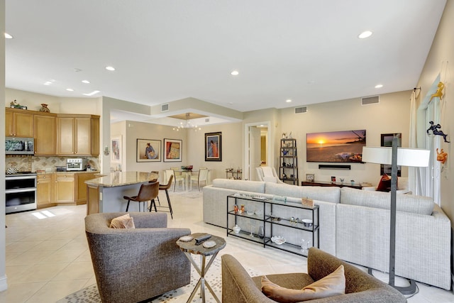 tiled living room with a chandelier