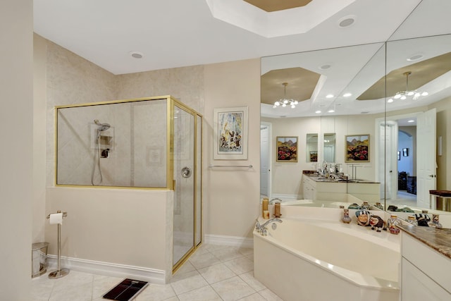 bathroom with vanity, a tray ceiling, an inviting chandelier, tile patterned flooring, and shower with separate bathtub