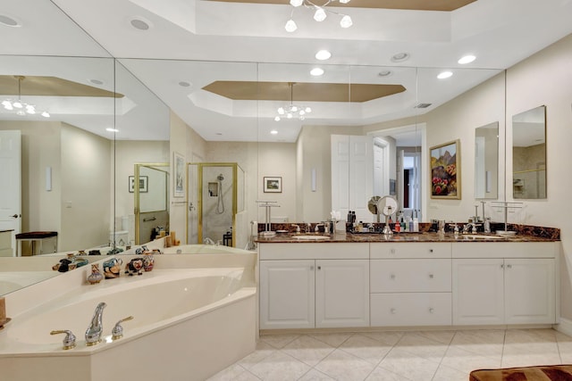 bathroom featuring tile patterned floors, vanity, a raised ceiling, and independent shower and bath