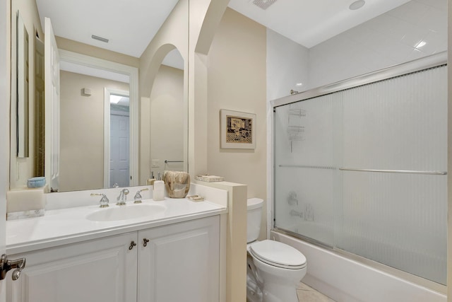 full bathroom with tile patterned floors, toilet, combined bath / shower with glass door, and vanity