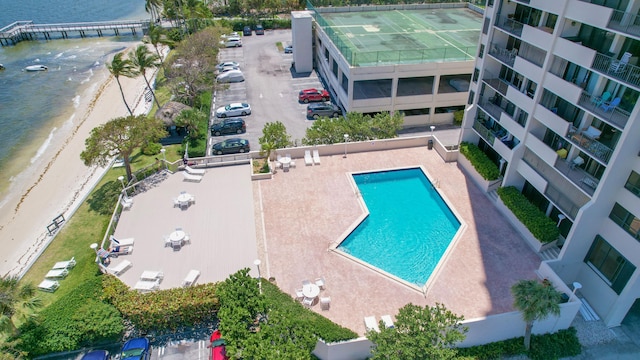 drone / aerial view featuring a water view and a view of the beach