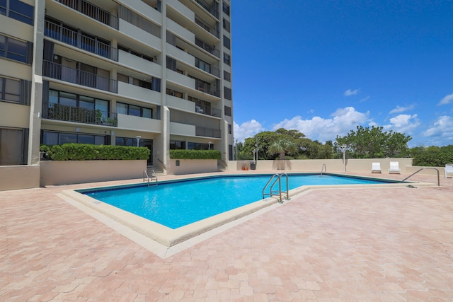 view of swimming pool featuring a patio area