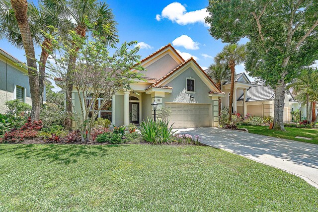 mediterranean / spanish-style house with a front lawn and a garage