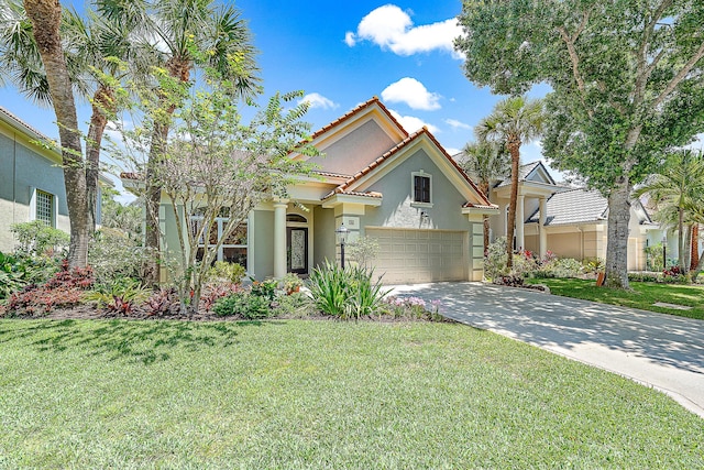 mediterranean / spanish-style house featuring driveway, a tiled roof, a front lawn, and stucco siding