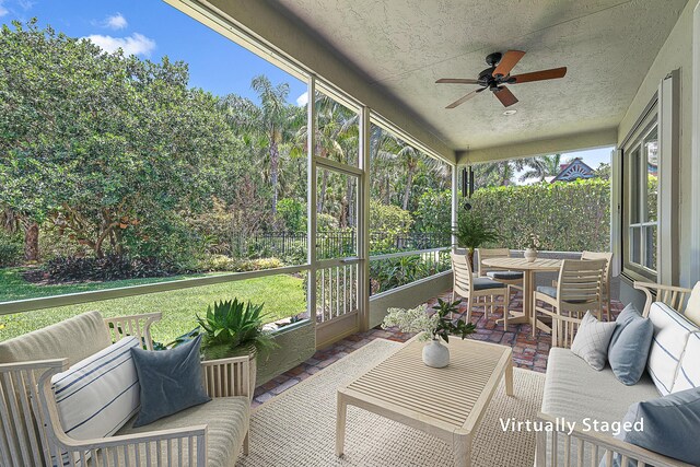 sunroom featuring ceiling fan