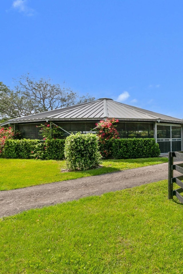 view of side of home with a lawn