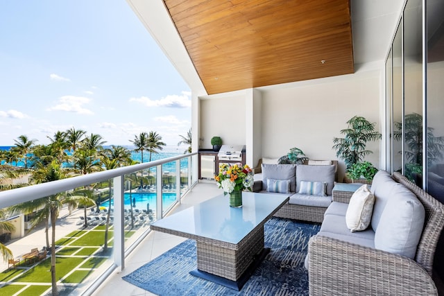 balcony with an outdoor living space and grilling area