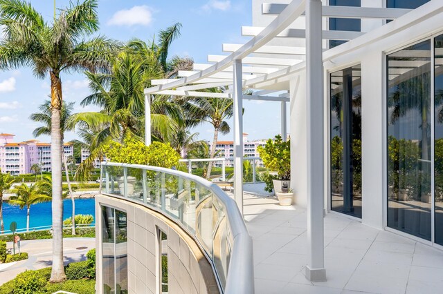 exterior space with a water view and a pergola