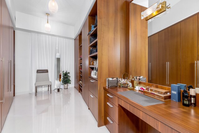 office featuring wooden walls and light tile patterned flooring