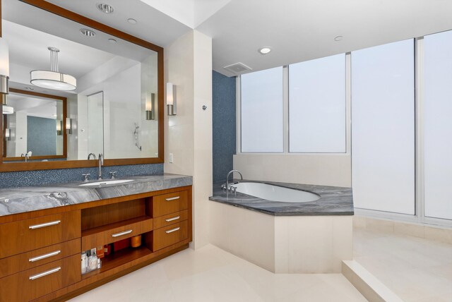 bathroom featuring vanity and a tub to relax in