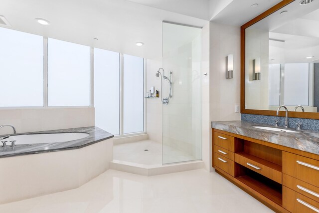 bathroom featuring vanity and separate shower and tub