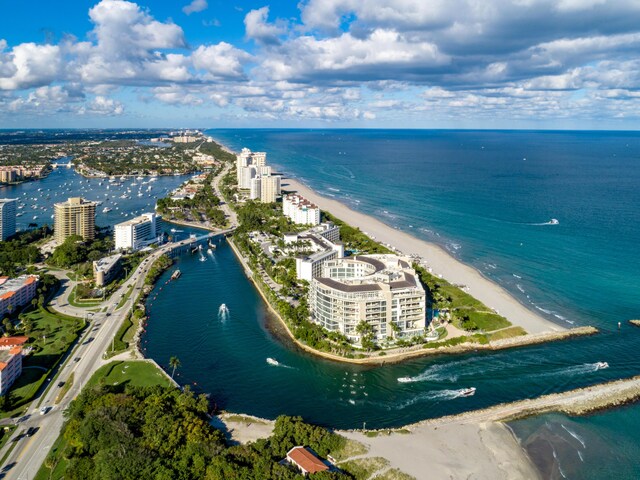 drone / aerial view featuring a water view and a view of the beach