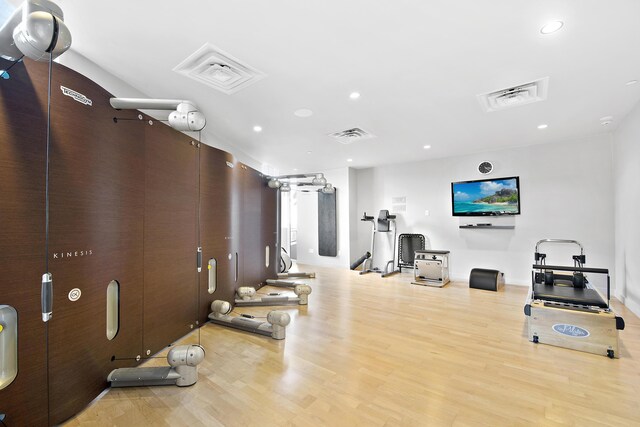 gym featuring light hardwood / wood-style floors