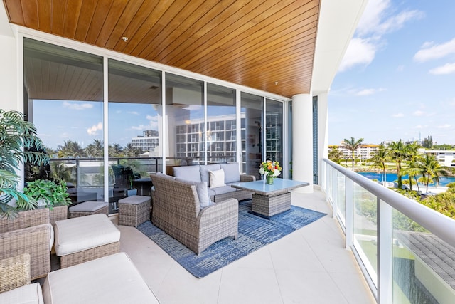 balcony featuring a water view and an outdoor hangout area