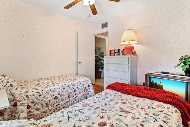 bedroom with ceiling fan and wood-type flooring