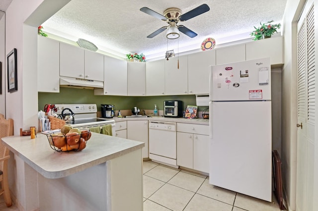 kitchen featuring sink, light tile patterned floors, kitchen peninsula, white appliances, and white cabinets