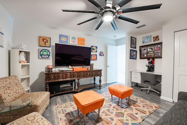 living room with light hardwood / wood-style floors and ceiling fan