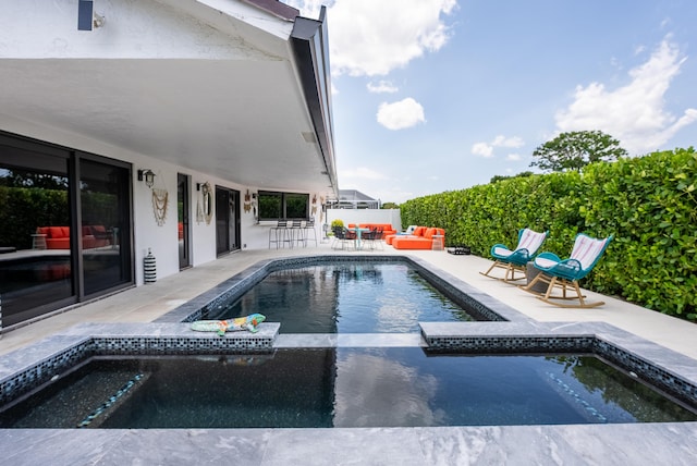 view of pool featuring a patio area, an outdoor hangout area, and an in ground hot tub