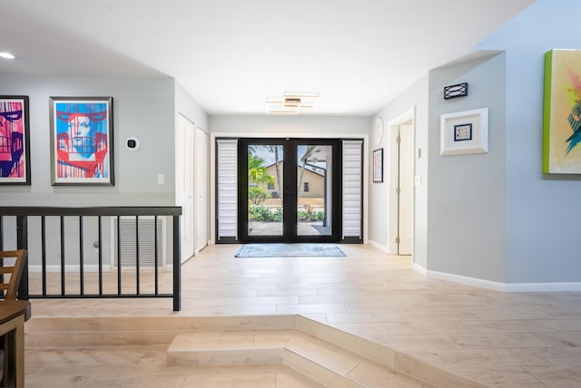 entrance foyer featuring light hardwood / wood-style floors and french doors