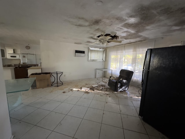 interior space featuring a wall mounted AC and ceiling fan