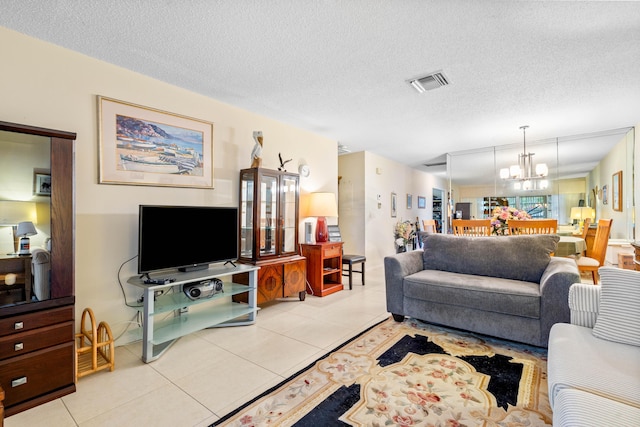 living room featuring a chandelier, a textured ceiling, and light tile patterned flooring