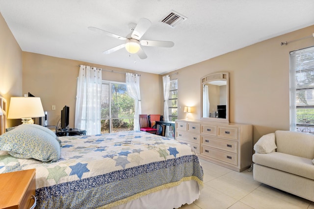 tiled bedroom featuring multiple windows and ceiling fan