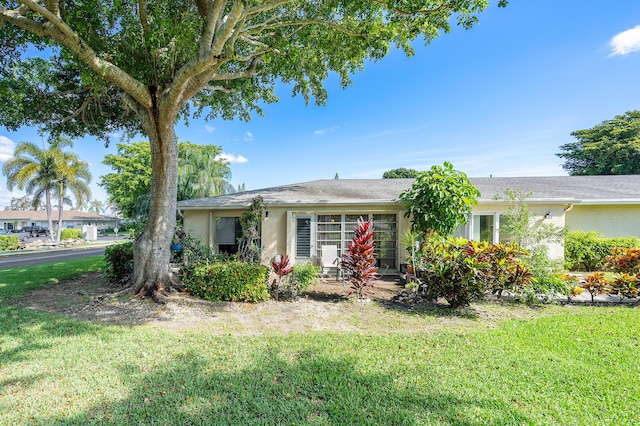 ranch-style home featuring a front yard