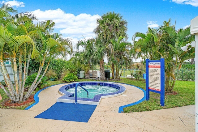 view of swimming pool featuring a hot tub