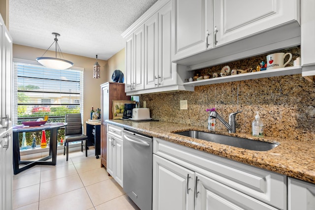 kitchen featuring white cabinets, a textured ceiling, sink, dishwasher, and hanging light fixtures