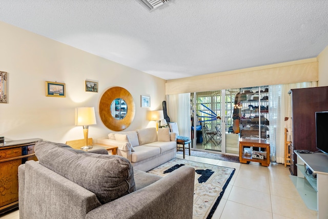 living room featuring light tile patterned flooring and a textured ceiling