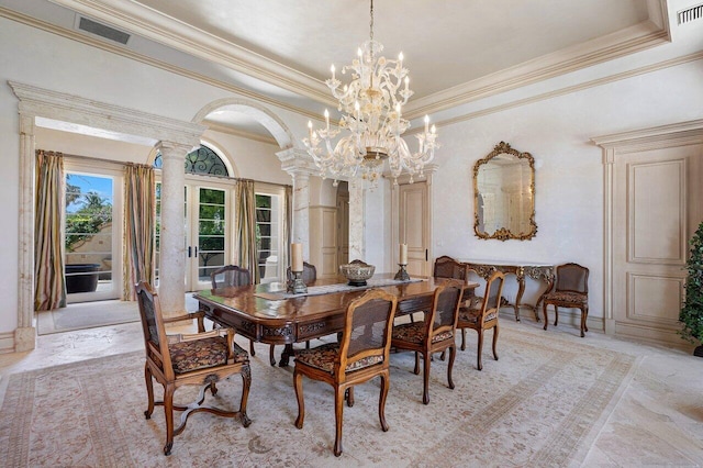 dining space featuring visible vents, arched walkways, a raised ceiling, ornate columns, and a chandelier