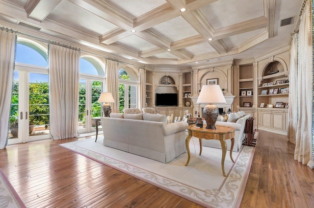 living area with french doors, visible vents, wood-type flooring, and beam ceiling