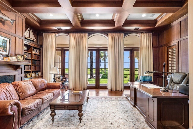 interior space featuring a high end fireplace, french doors, wood-type flooring, built in shelves, and coffered ceiling