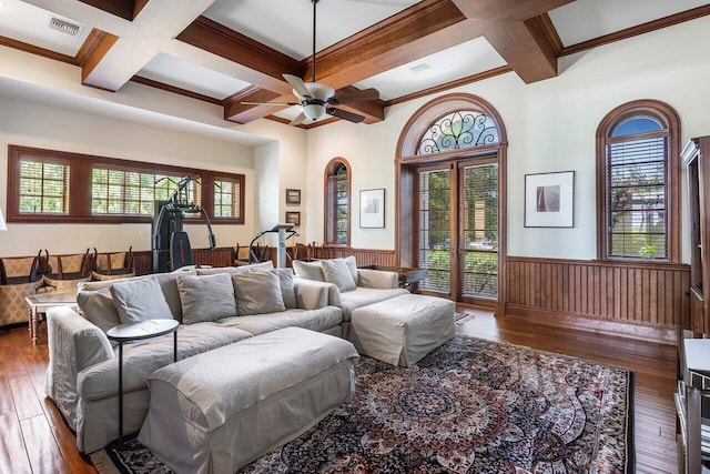 living room featuring coffered ceiling, beam ceiling, wainscoting, and hardwood / wood-style floors