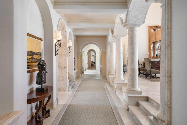 hall featuring arched walkways, beamed ceiling, decorative columns, and crown molding