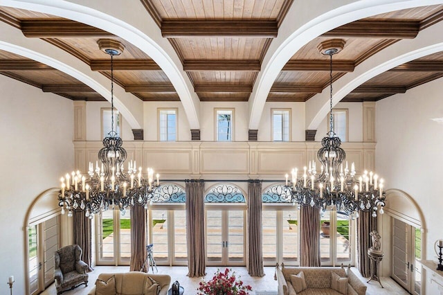 interior space with a chandelier, a wealth of natural light, and wood ceiling