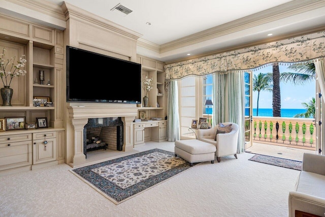 living room featuring built in shelves, crown molding, light carpet, and a water view