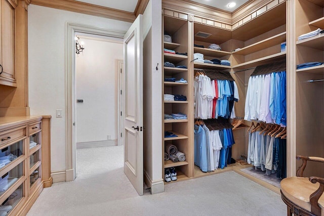 walk in closet featuring light carpet