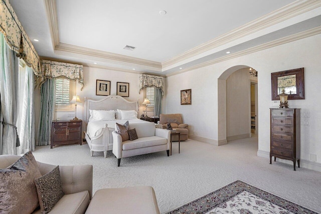 bedroom with visible vents, arched walkways, a tray ceiling, and carpet flooring